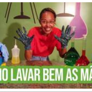 Na foto com cenário de laboratório uma mulher com as mãos sujas de tinta. Na parte inferior escrito: "Como lavar bem as mãos?"
